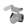 The Sony FX30 is mounted in the SmallRig Handheld Cage Kit 4184, equipped with a large lens, top handle, and an external microphone fitted with a grey furry windscreen.